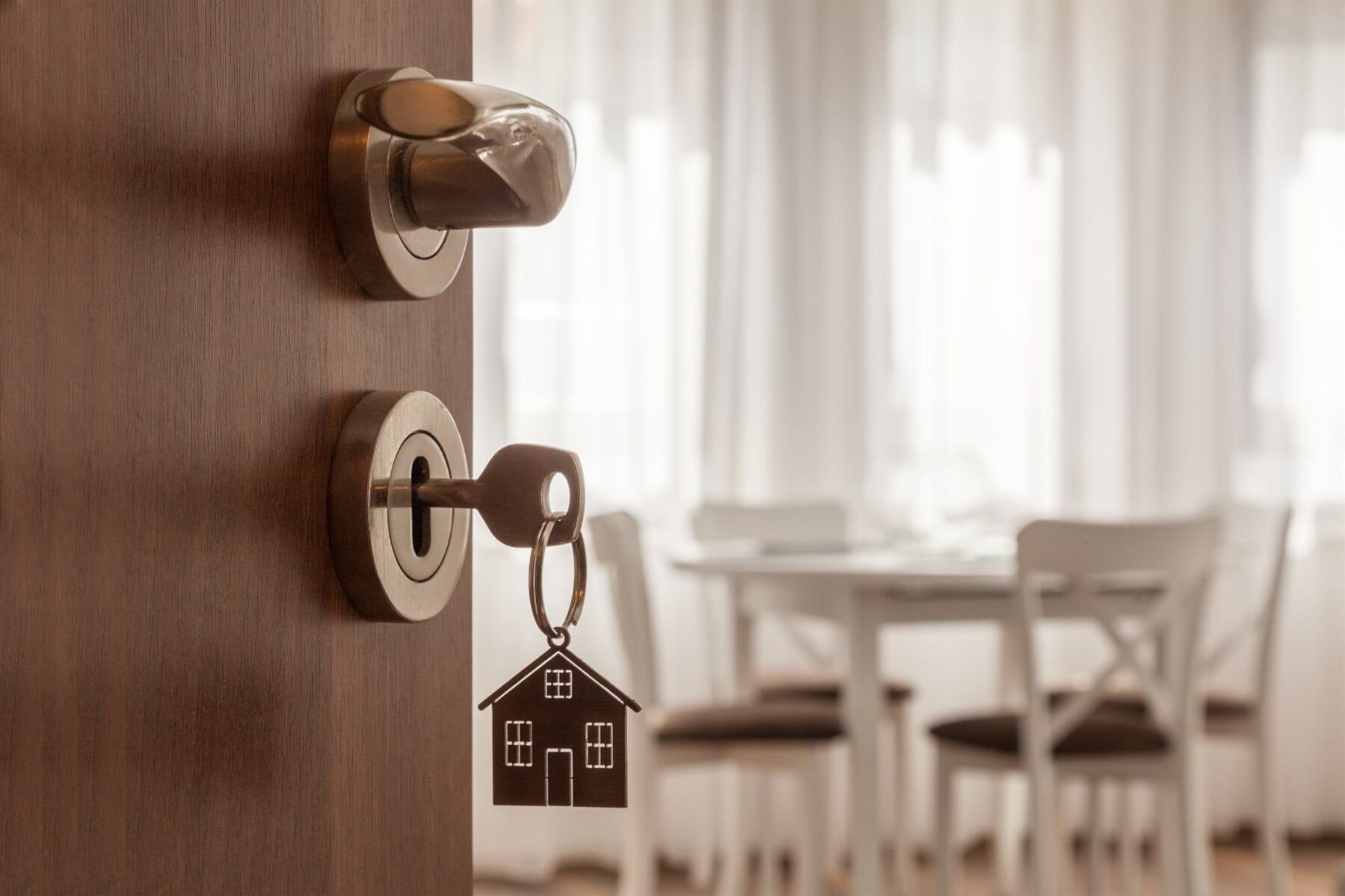 A Door with A Key in It Is Open to A Dining Room — Lock & Door in Wodonga, VIC