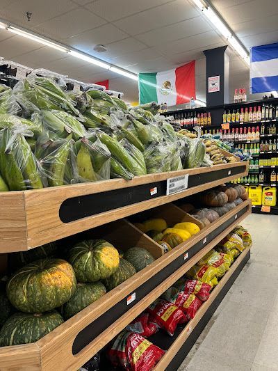A grocery store aisle filled with lots of fruits and vegetables.