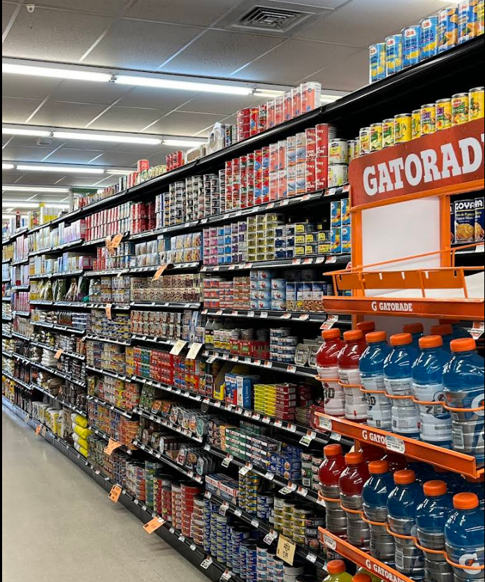 A grocery store aisle with gatorade bottles on shelves