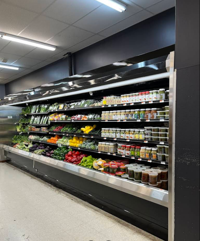 A grocery store aisle filled with fruits and vegetables