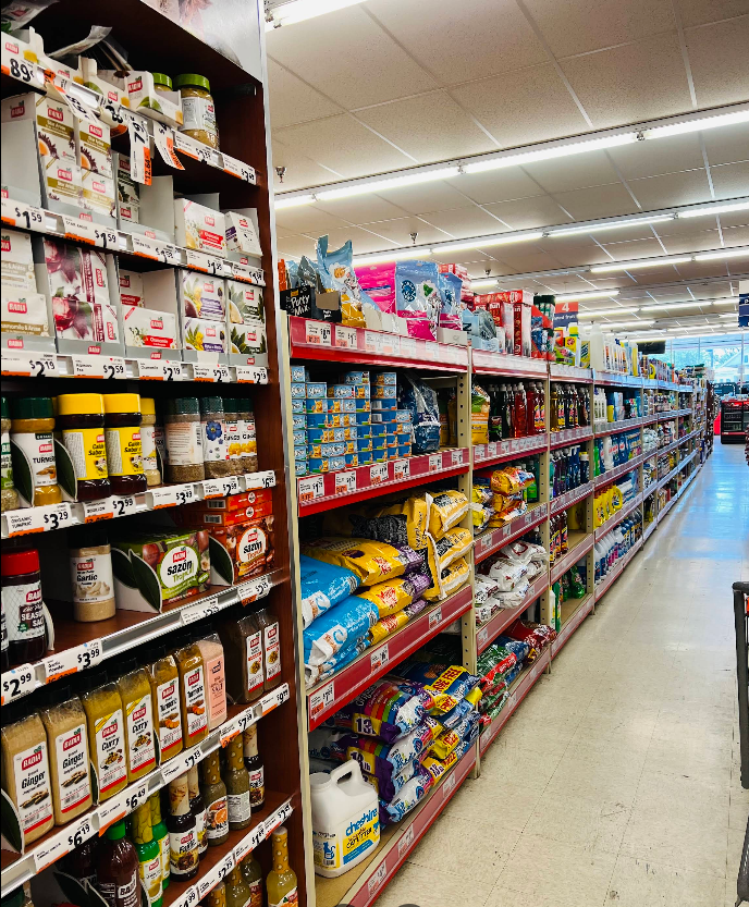 A long aisle of a grocery store filled with lots of products.
