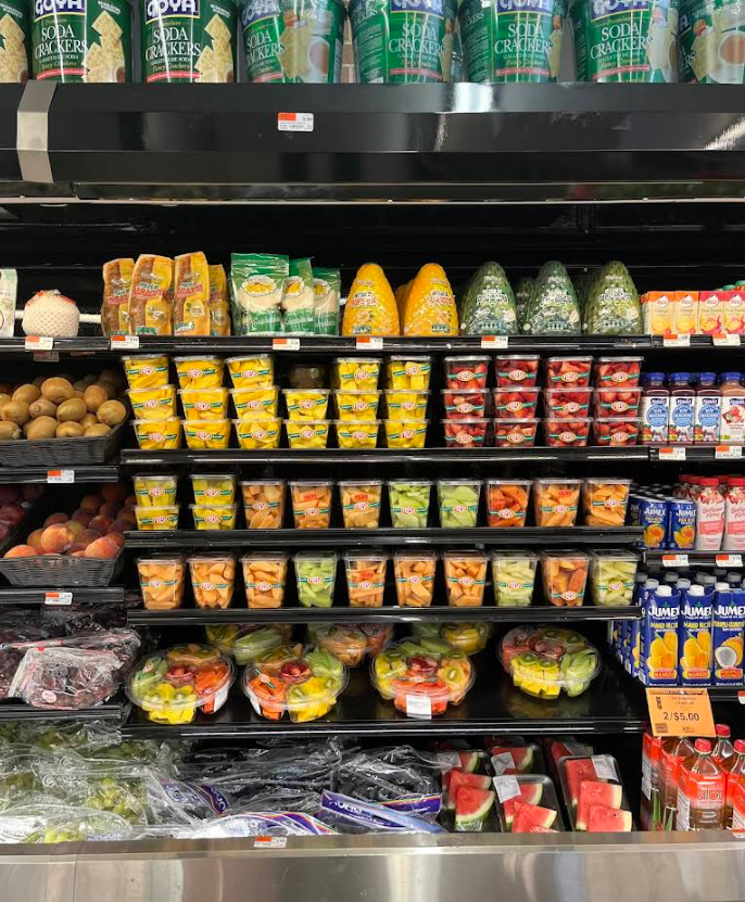 A grocery store refrigerator filled with lots of fruits and vegetables