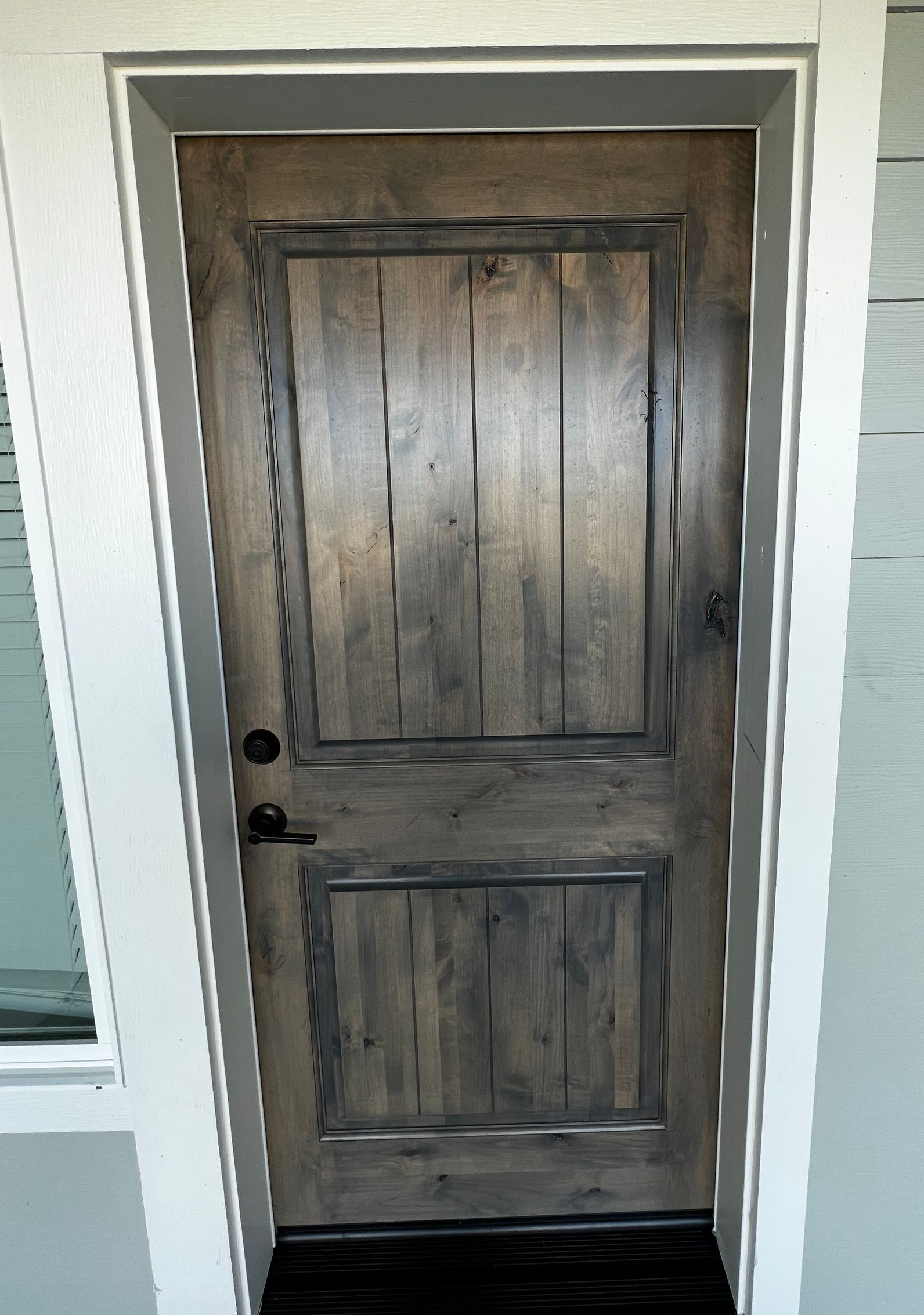 Two people painting a room. One is on a ladder, the other uses a roller.