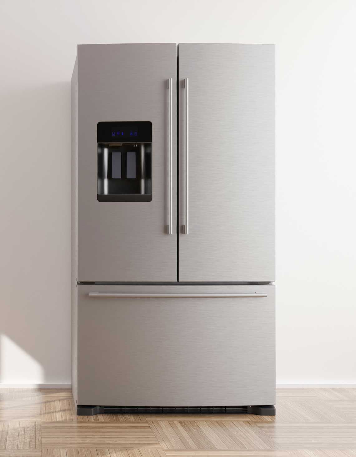 A stainless steel refrigerator is sitting on a wooden floor in a kitchen.
