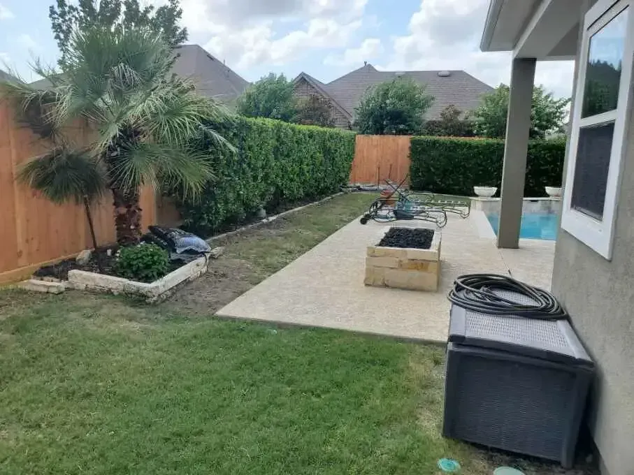 A backyard with a fence , a patio , and a pool.