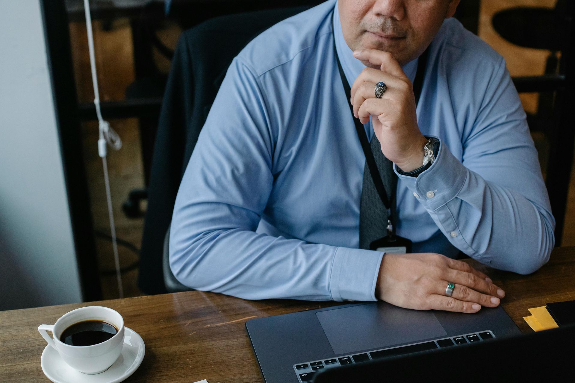 Business man thinking while using his laptop with a cup of coffee - Business and Notary Solutions, LLC - Spring, TX