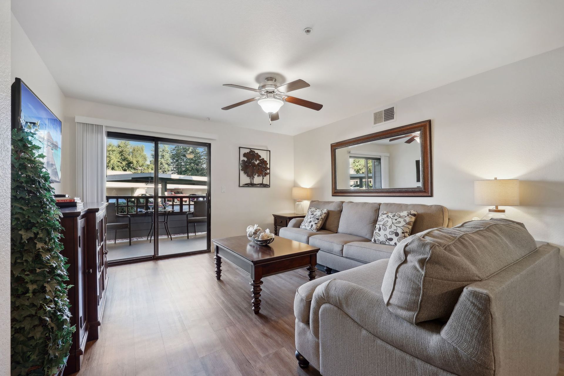 Living room with a sofa, coffee table, and sliding glass door to a balcony.