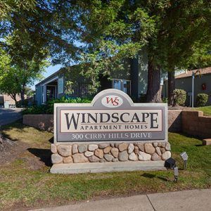 Windscape Apartment Homes sign with address 300 Kirby Hills Drive in front of building and landscaping.