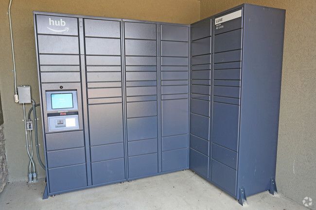 Dark blue Amazon Hub locker system with touchscreen panel, outdoors.