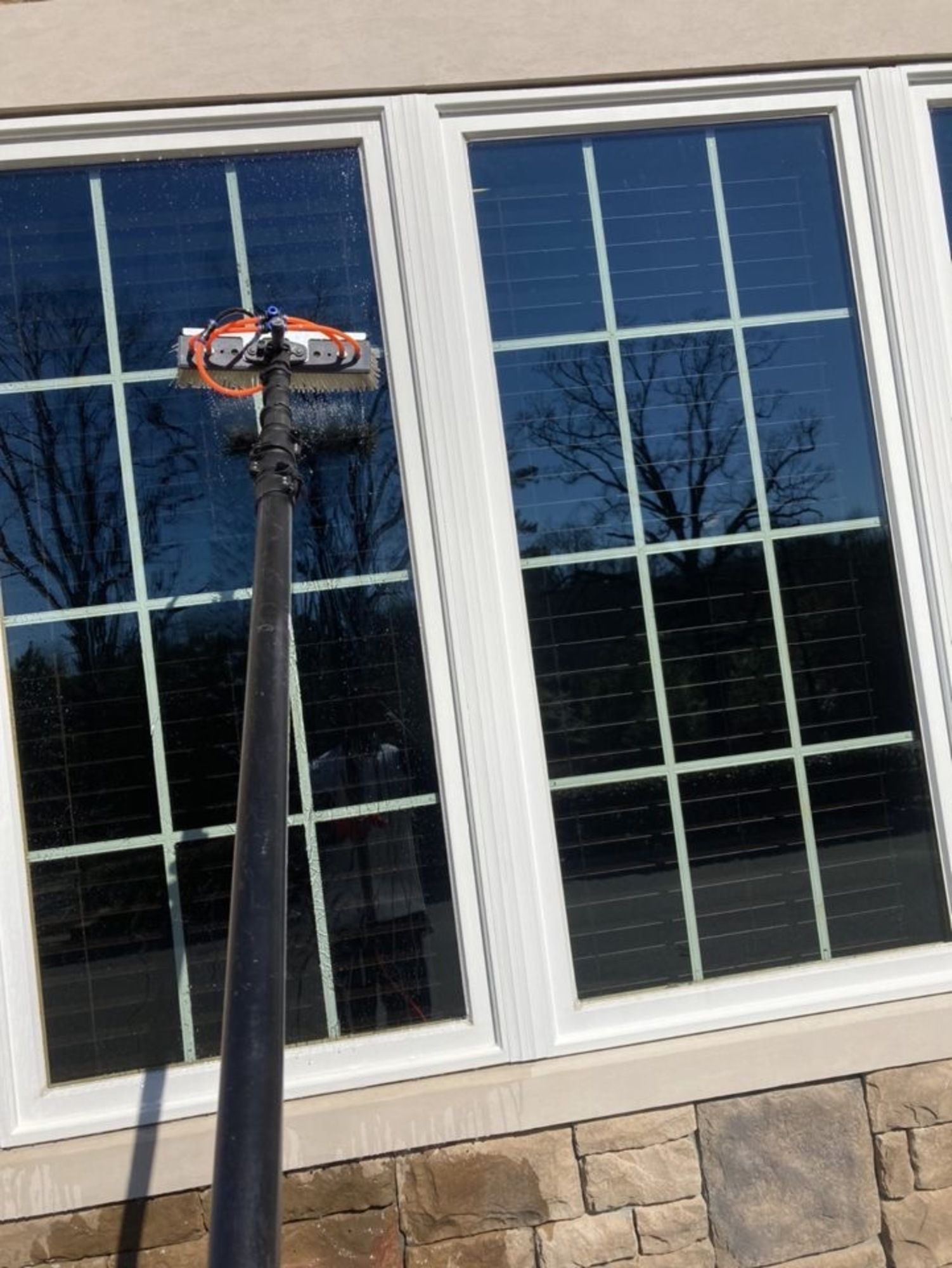 A window cleaner is cleaning the windows of a house