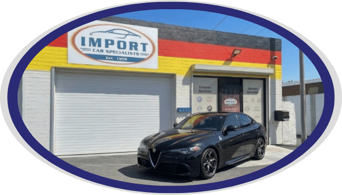 Alfa Romeo sedan in front of Import Car Specialists shop