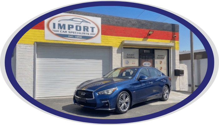 Infiniti sedan in front of Import Car Specialists shop