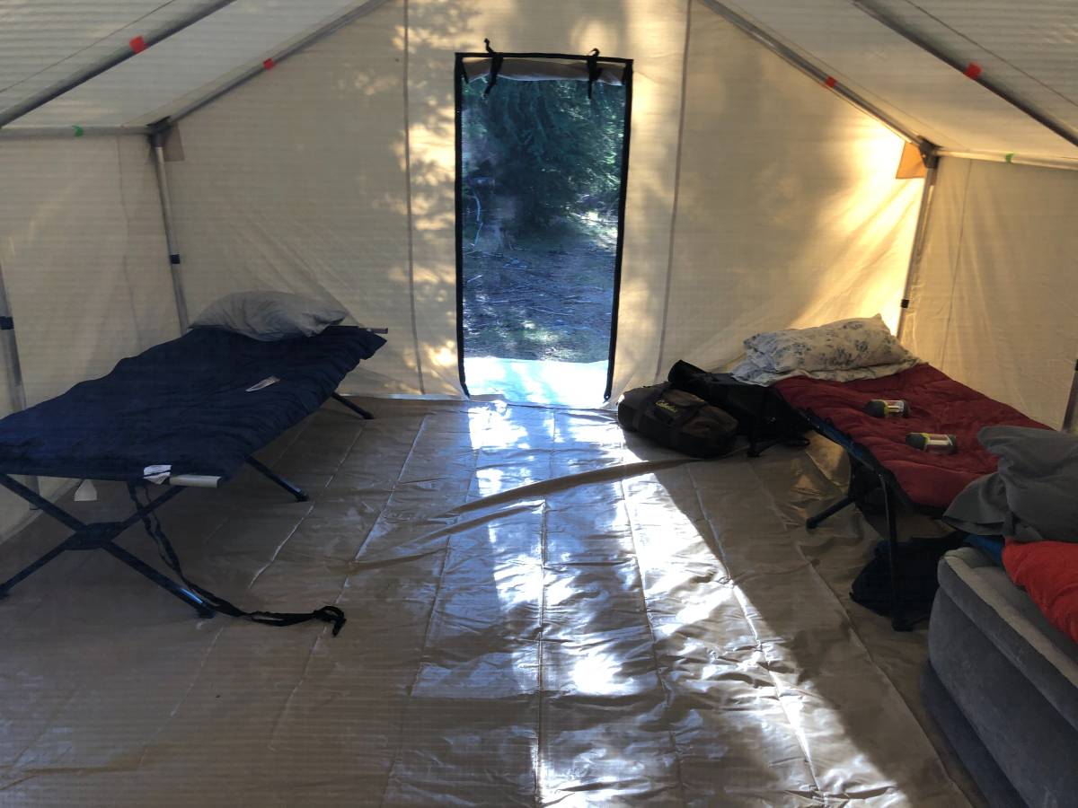 A tent with a blue bed and a red mattress