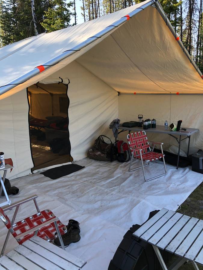 A tent with a table and chairs inside of it
