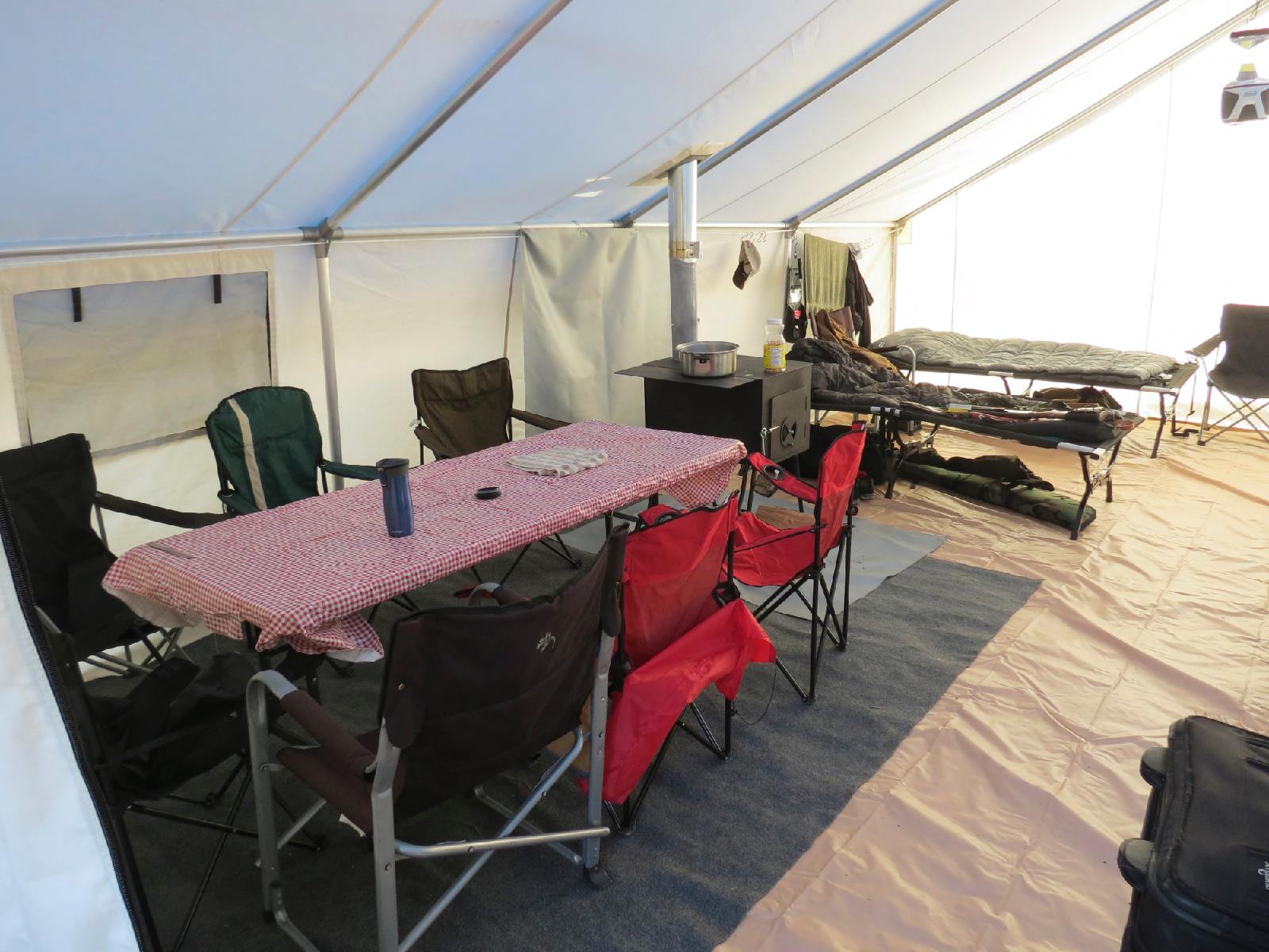 A tent with a table and chairs inside of it