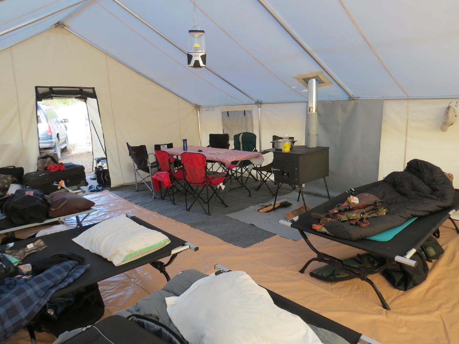 A tent with a table and chairs inside of it