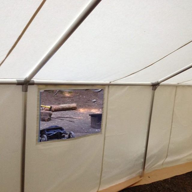 The inside of a tent with a small window