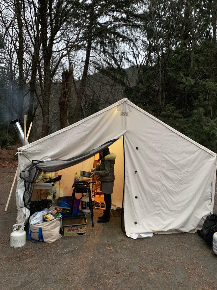 A white tent with a person inside of it