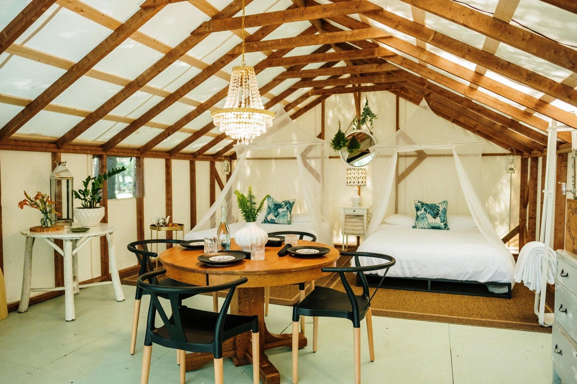 There is a table and chairs in the middle of the room.