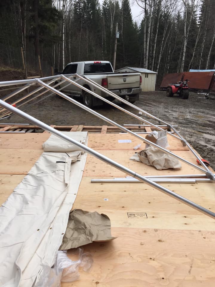 A truck is parked on the side of the road next to a tent.