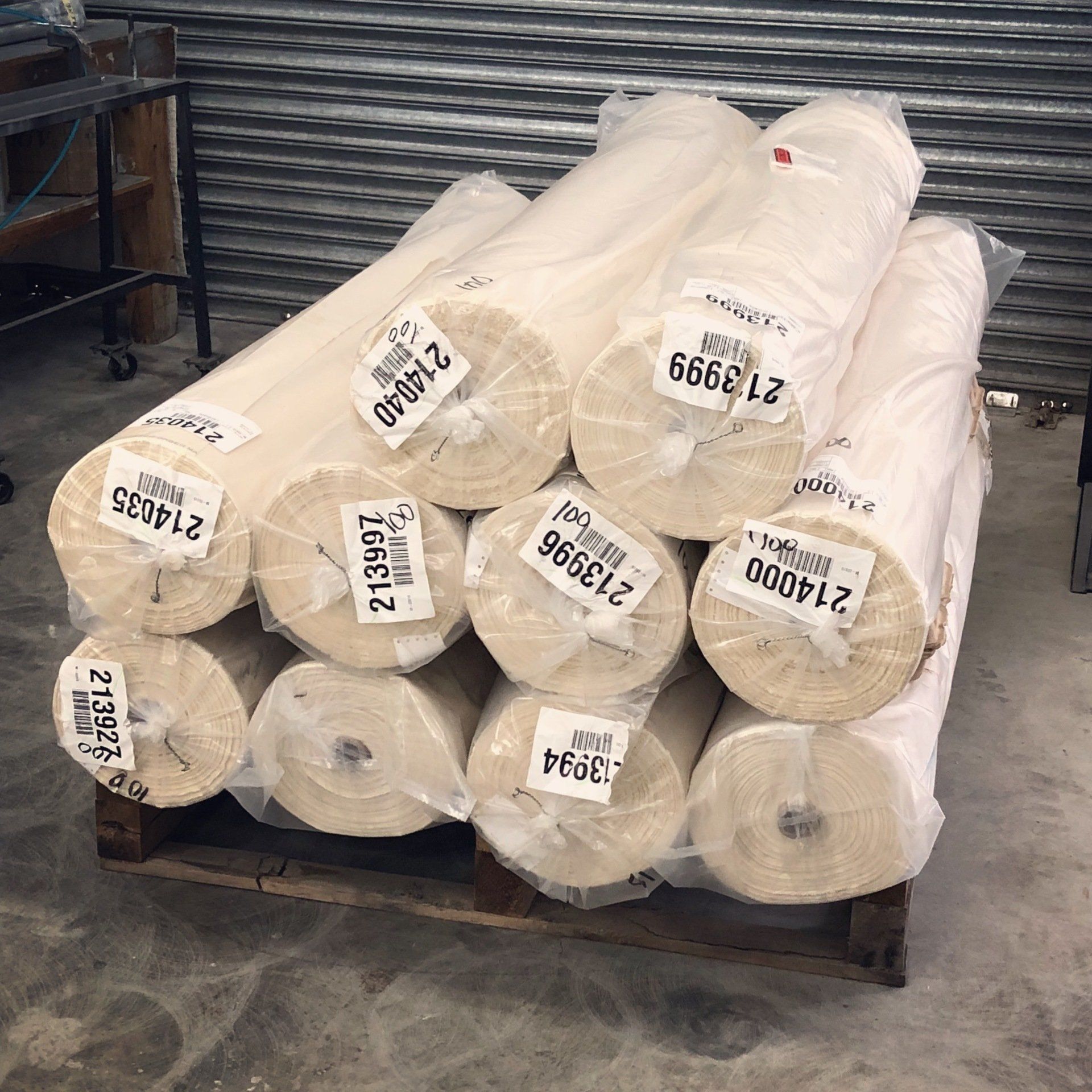 A bunch of rolls of fabric are stacked on top of each other