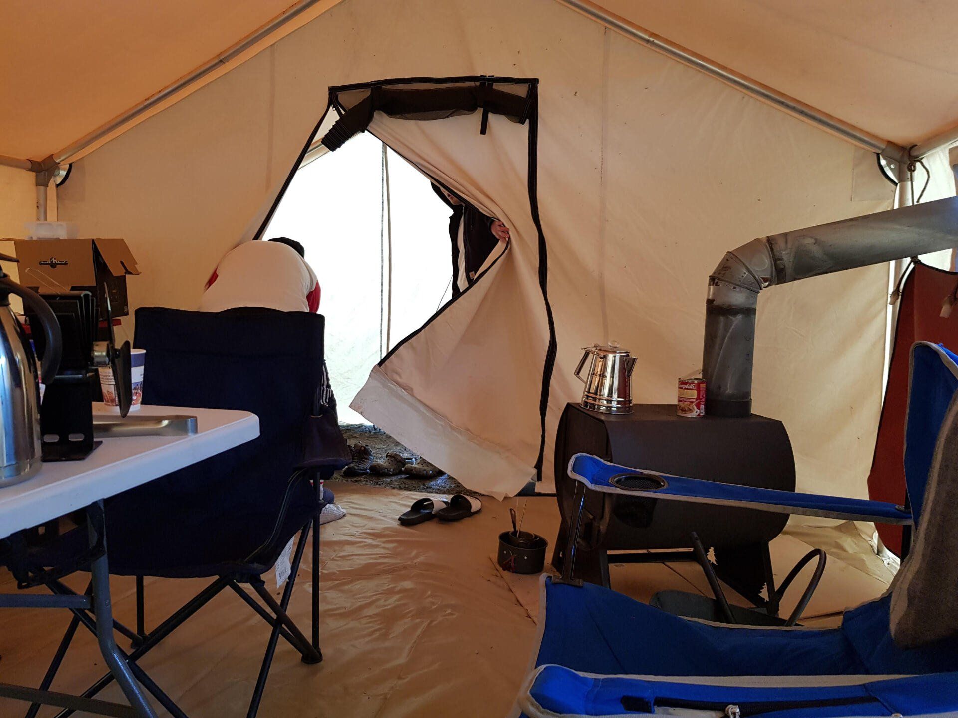A tent with a table and chairs inside of it