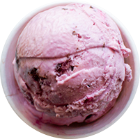 A scoop of purple ice cream in a cup on a white background.