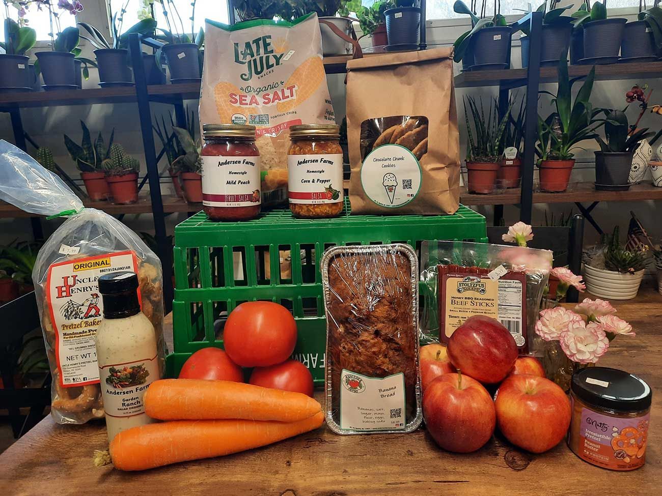 A wooden table topped with a variety of fruits and vegetables.
