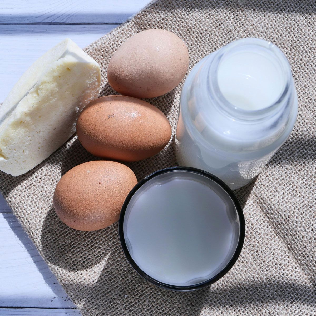 Eggs butter and a bottle of milk on a table