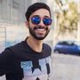 A man wearing sunglasses and a shirt that says nyc