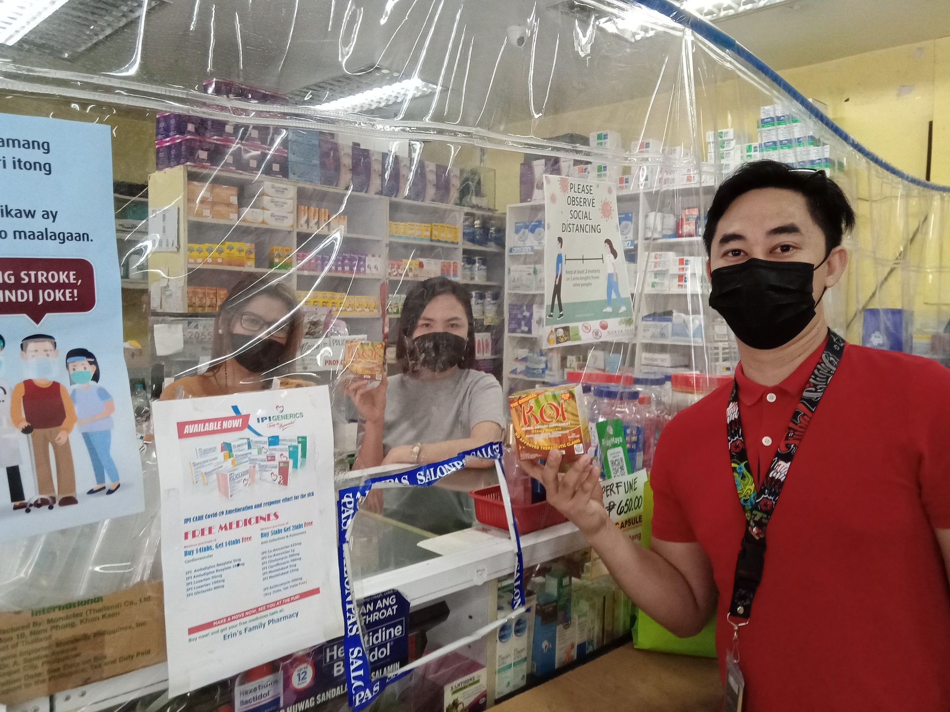A man wearing a mask is standing next to a woman wearing a mask in a pharmacy.