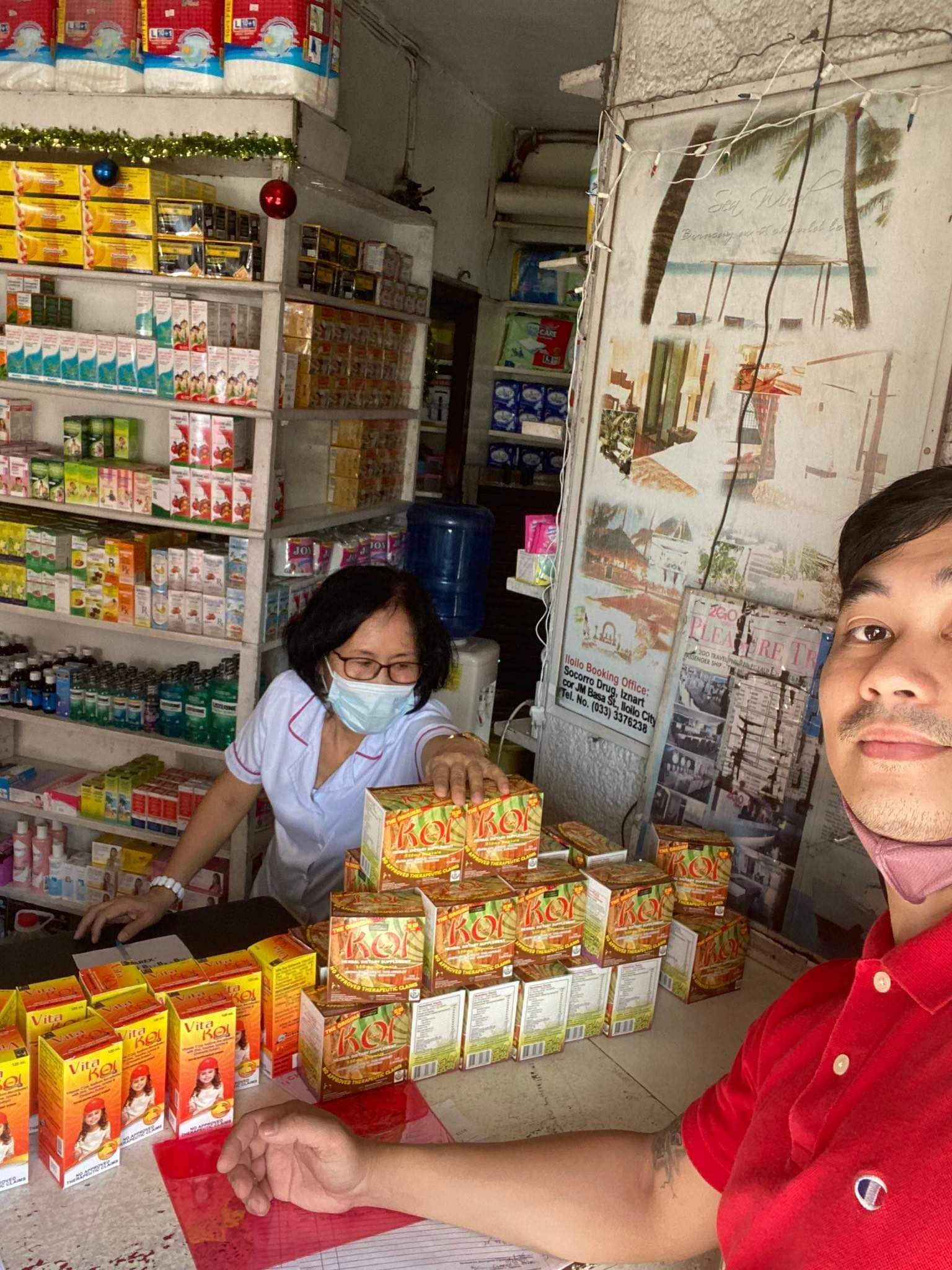 A man and a woman are sitting at a table in a store.