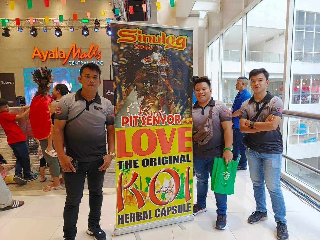 A group of men are standing in front of a sign that says `` love the original koi ''.