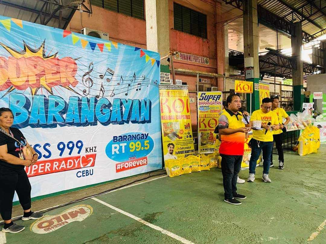 A group of people are standing in front of a large sign.