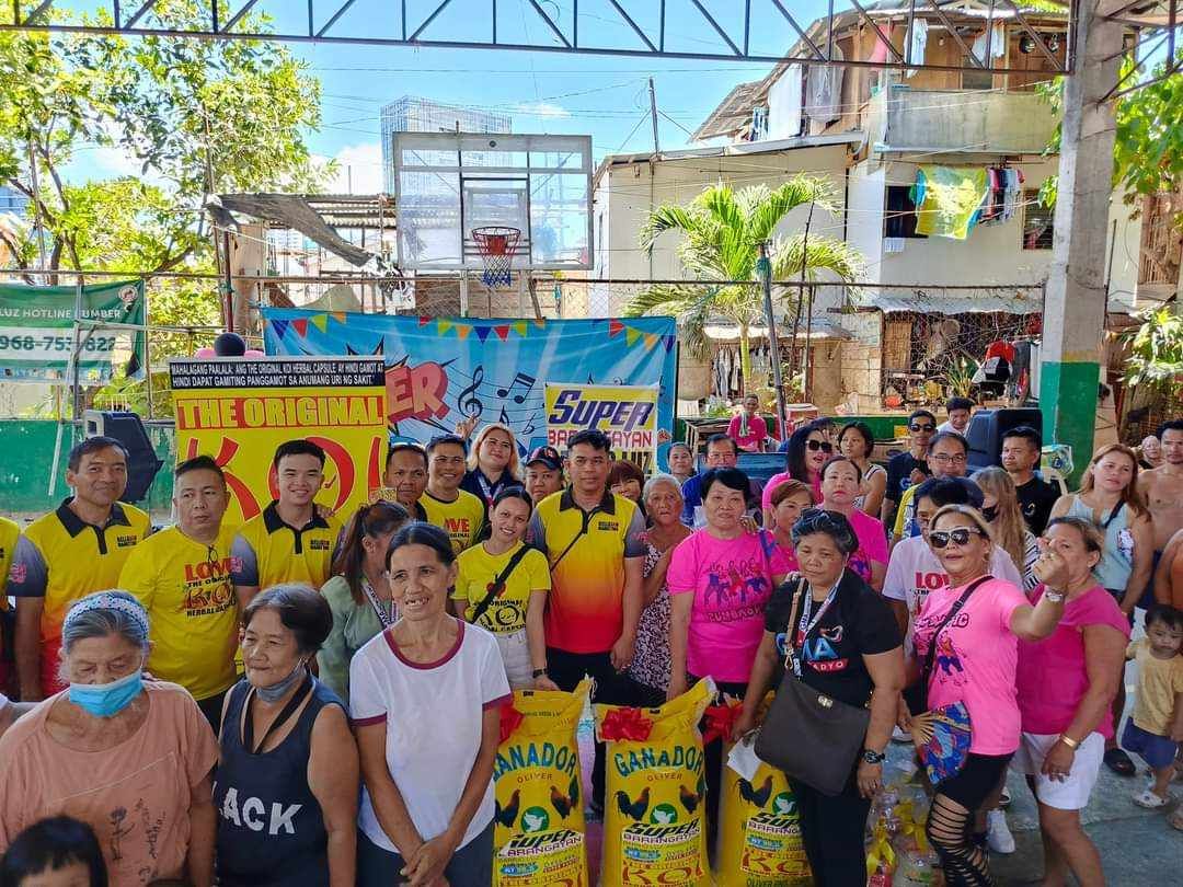 A group of people are posing for a picture in front of a basketball hoop.