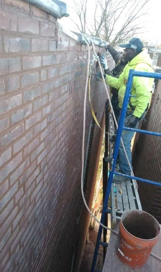 A man is smiling for the camera holding selection of tile . Clair Panglinan