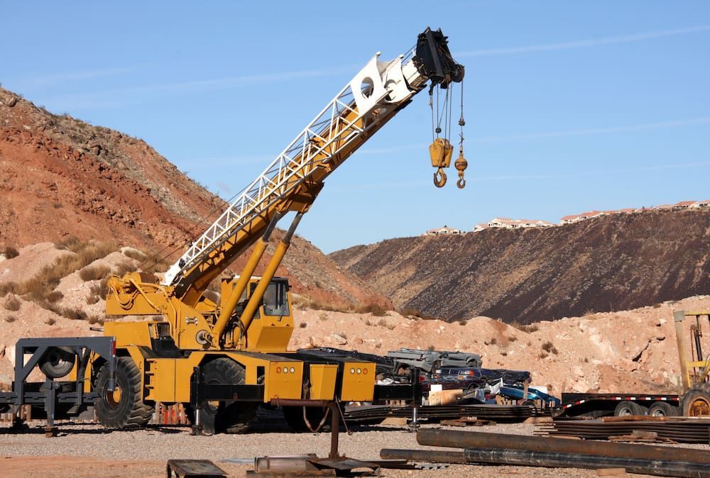 A Large Yellow Crane is Sitting in the Middle of a Desert — Smithys Crane Hire in Gordonvale, QLD