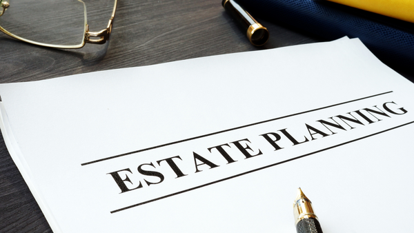 A piece of paper with the word estate planning written on it