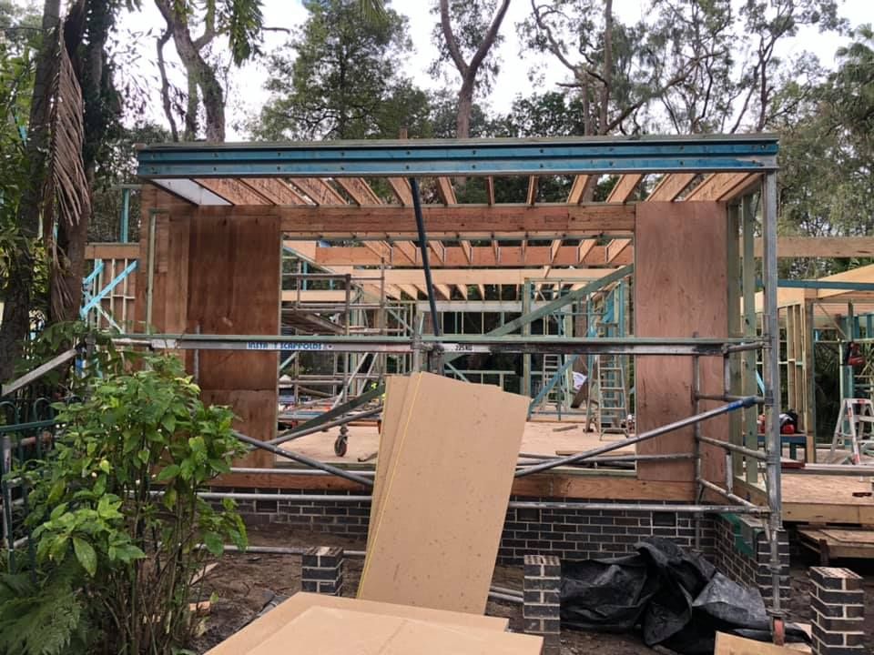 A house is being built with a lot of wood and bricks.