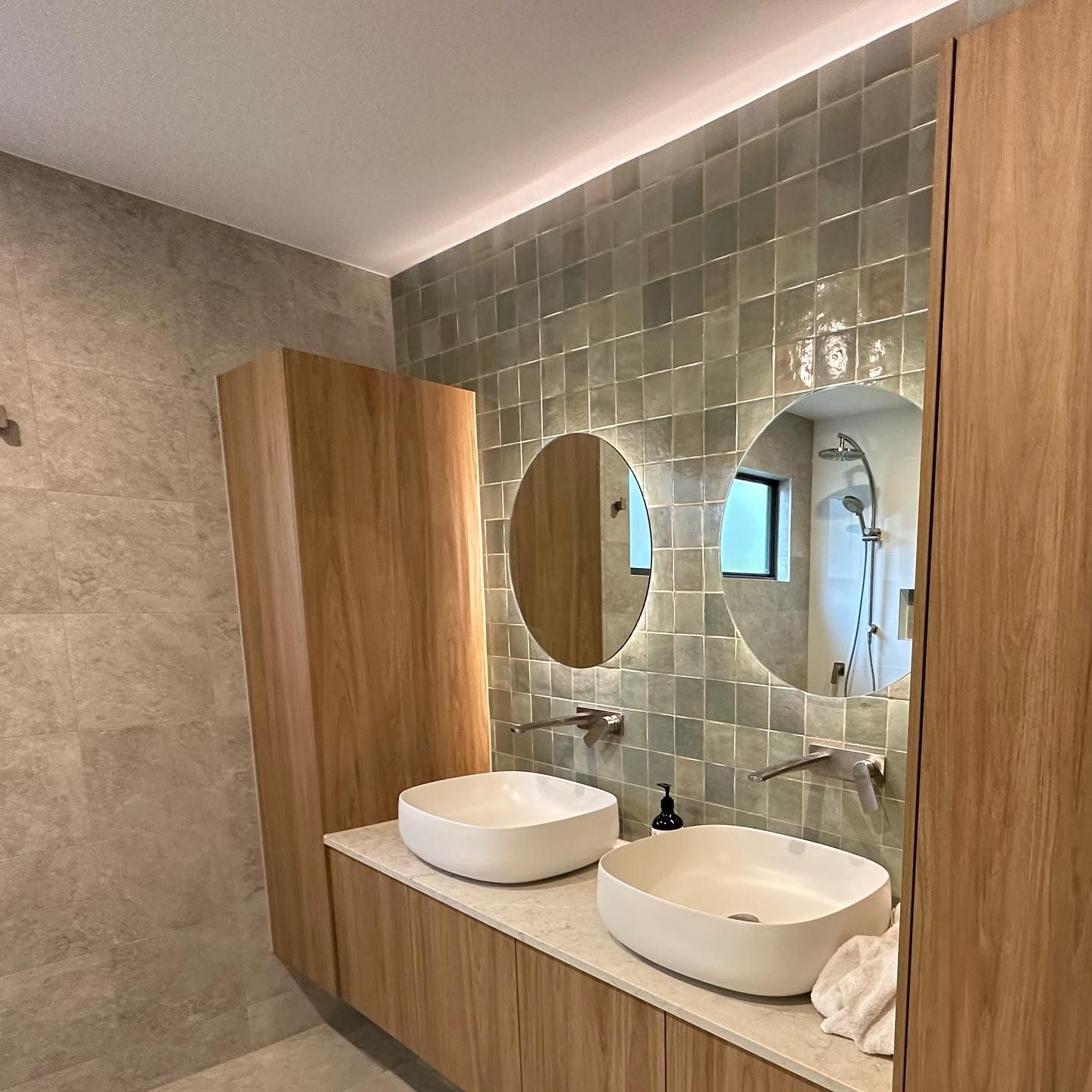 A bathroom with two sinks and two mirrors.