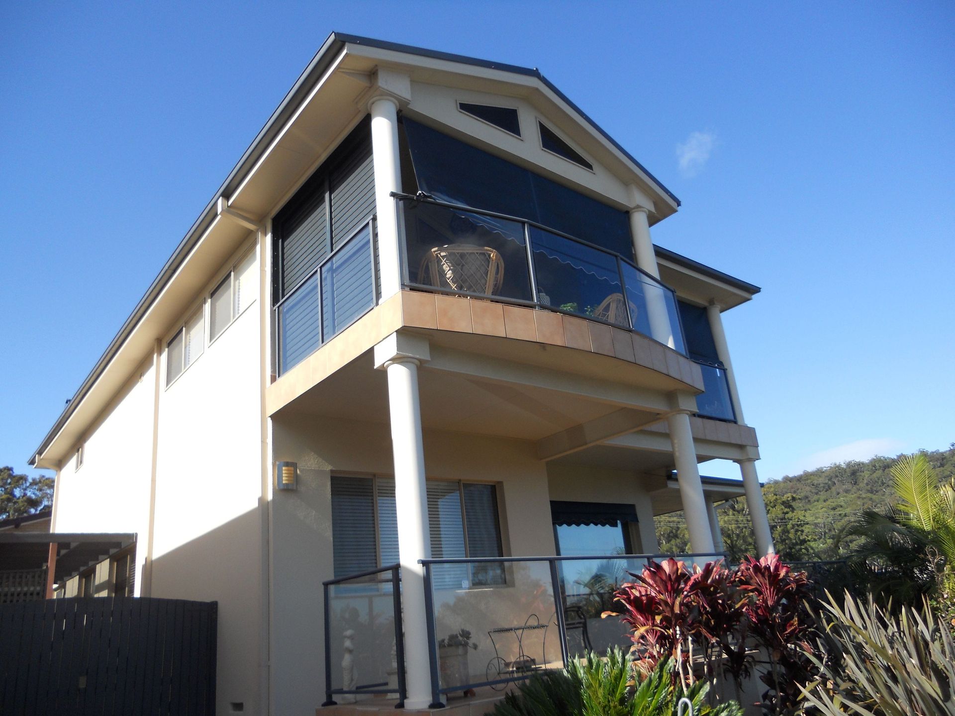 A large house with a car parked in front of it.