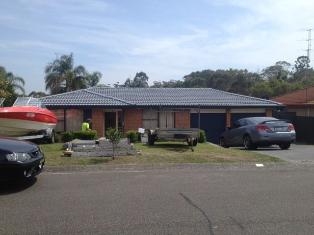 A boat is parked in front of a house