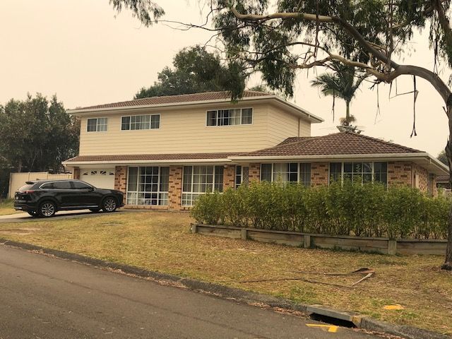 A large house with a car parked in front of it.