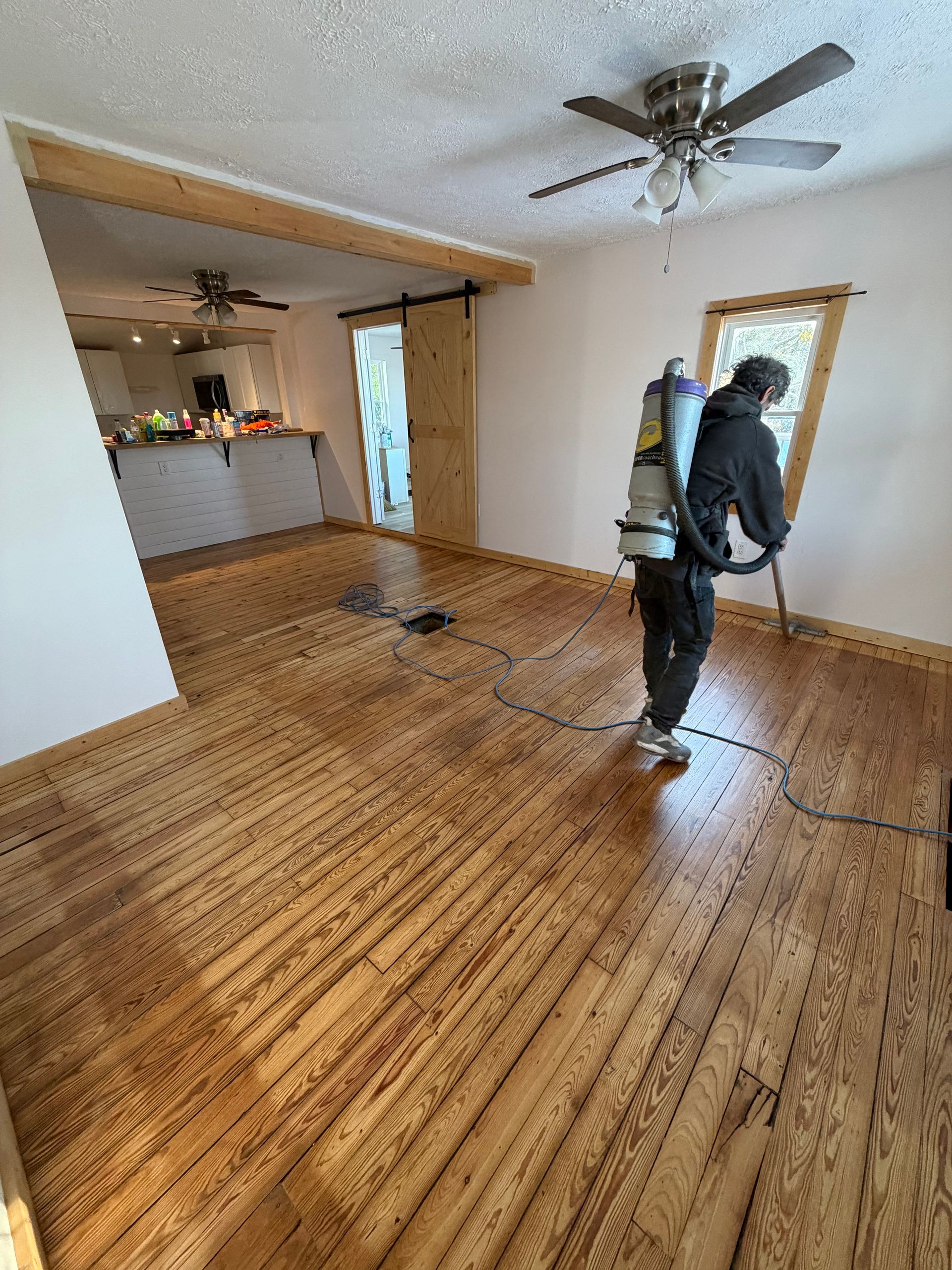 Worker applying final polyurethane finish coat
