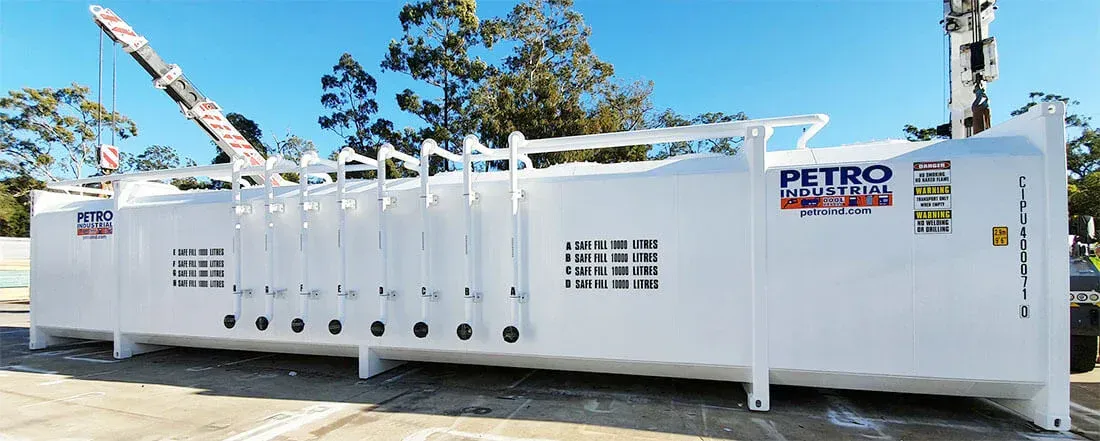 A large white tank is sitting in a parking lot.