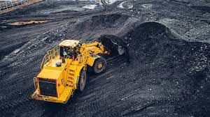A large excavator is working in a coal mine.