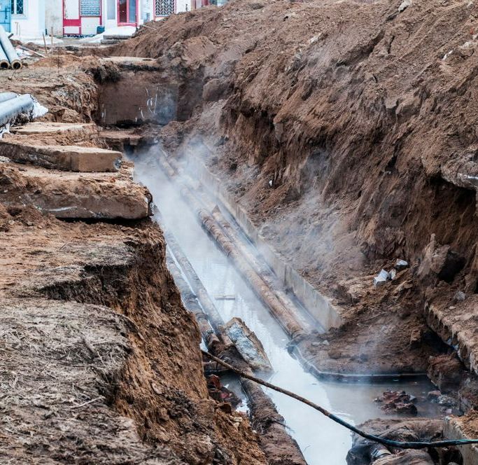 A Broken Pipe is Being Repaired in a Trench — Copp & Co Civil & Plant Hire in Proserpine, QLD