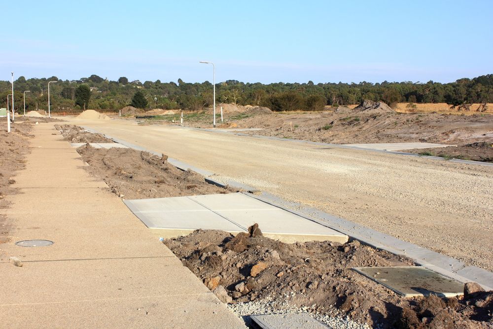 A Dirt Road With a Sidewalk in the Middle of It — Copp & Co Civil & Plant Hire in Bowen, QLD