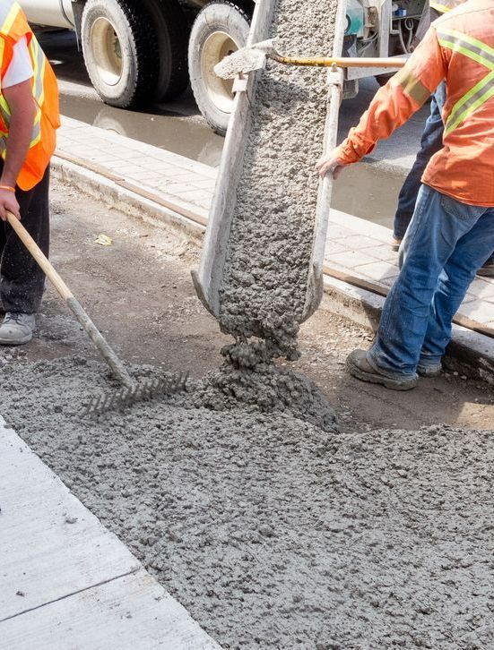 Two Construction Workers Are Pouring Concrete on a Sidewalk — Copp & Co Civil & Plant Hire in Bowen, QLD