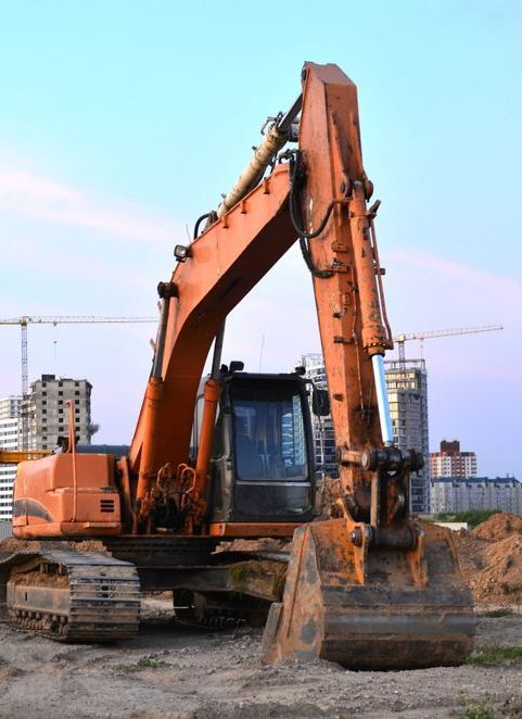 A Large Orange Excavator is Parked on a Construction Site — Copp & Co Civil & Plant Hire in Cannonvale, QLD
